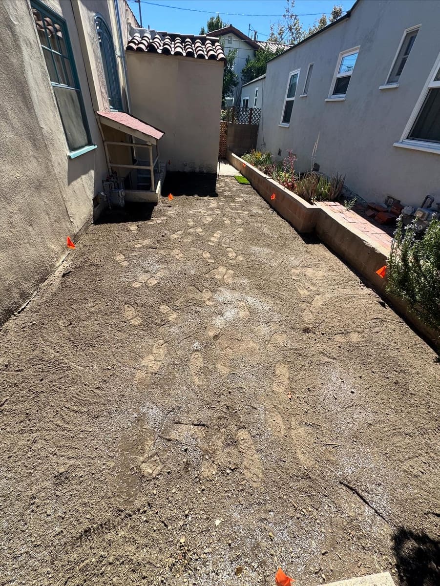 Side yard graded with a new border retaining wall